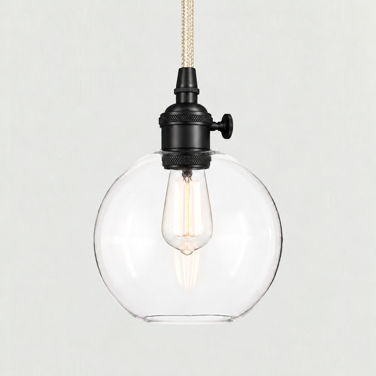 Bronze(Small) clear glass globe pendant on a plain background