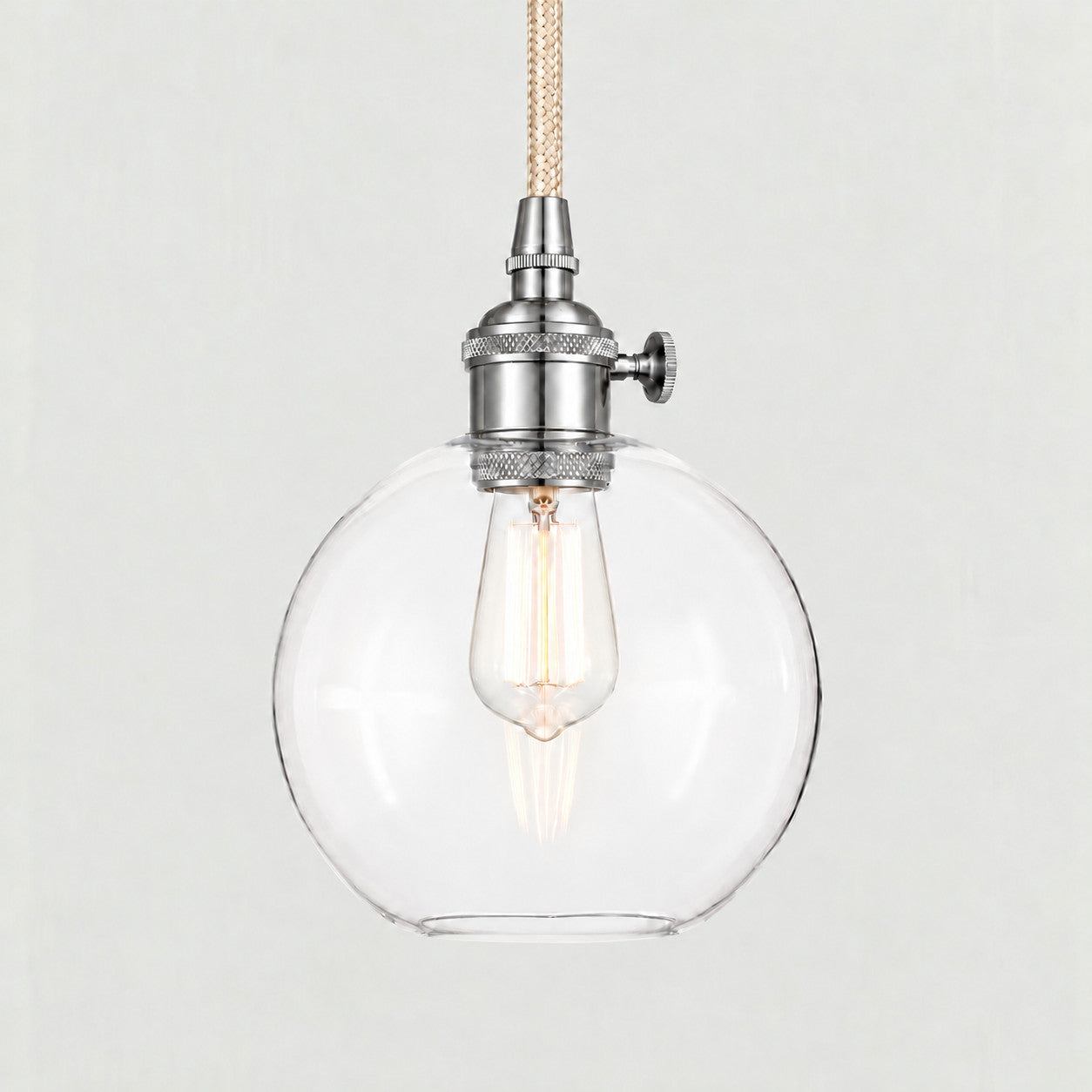 Nickel(Small) clear glass globe pendant on a plain background